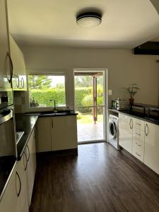 a kitchen with a sink and a washer and dryer at Family Villa with Large Garden in Pissouri