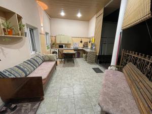 a living room with a couch and a kitchen at Hotel Home in Tashkent