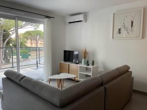 a living room with a couch and a table at RIVIERA COTTAGE in Mandelieu-La Napoule