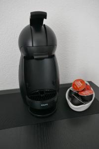 een zwart koffiezetapparaat op een zwart aanrecht bij Le Green Set in Pornic