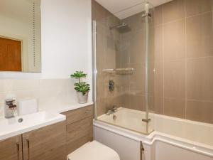 a bathroom with a shower and a toilet and a sink at Jacana in Perranporth +26 photos