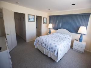 a bedroom with a bed and two lamps on tables at Ocean Front, Wi-Fi, Atlantic Views, 10 Beach Badges And Chairs, Outdoor Shower, Jacuzzi-Jet Tub, Decks Ping Pong Table, Private Yard,ship Bottom, in Ship Bottom