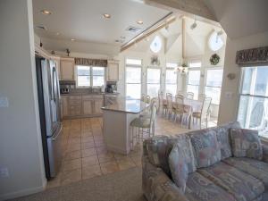 a kitchen and living room with a couch and a table at Ocean Front, Wi-Fi, Atlantic Views, 10 Beach Badges And Chairs, Outdoor Shower, Jacuzzi-Jet Tub, Decks Ping Pong Table, Private Yard,ship Bottom, in Ship Bottom