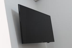 a flat screen tv hanging on a wall at Lofts Sayula Independencia in Sayula