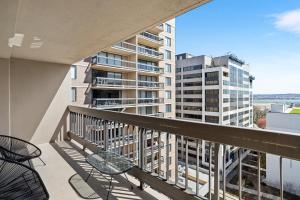 a balcony with chairs and a view of a building at Stylish Apt in Crystal City in Arlington