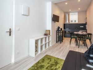 a living room and dining room with a table at Studio centre ville La Bourboule in La Bourboule