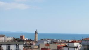 a view of a city with a lighthouse at B&B BuonaLuna in Salerno
