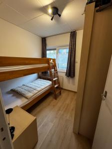 a room with two bunk beds and a window at Appartement Walvis nr 26 in Vrouwenpolder