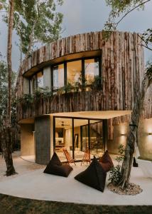 a house with a wooden wall with windows at Media Luna BoHo Chic Villa E11 Pvt Pool Concierge in Tulum