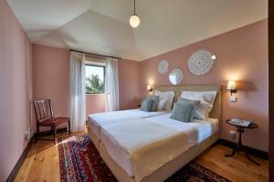 a bedroom with a large bed and a window at Bordal Houses in Funchal +50 photos