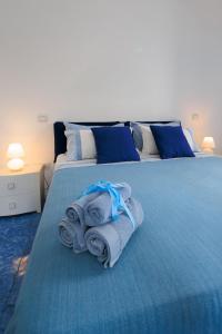 a bedroom with a blue bed with towels on it at Il Sogno in Erchie