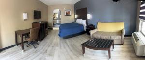 a hotel room with a bed and a desk at Deluxe Inn & Suites in York