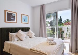 a bedroom with a bed with two towels on it at LuxVillasRentals Ayia Napa in Ayia Napa +70 photos