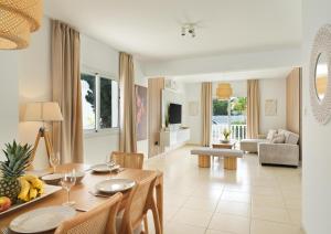 a dining room and living room with a table and chairs at LuxVillasRentals Ayia Napa in Ayia Napa