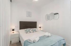 a bedroom with a bed with towels on it at CaLaNu Cap Salou Apartment by the sea in Salou +53 photos