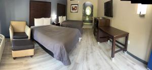 a hotel room with a bed and a desk at Deluxe Inn & Suites in York