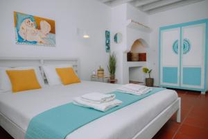 a bedroom with a bed with towels on it at Mayelia Ηouse in the old town in Rhodes Town