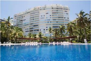 a view of the hotel from the pool at Great Beachfront Amara Condo Ixtapa in Ixtapa