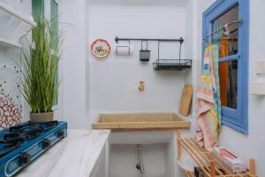 a bathroom with a sink and a blue door at Mayelia Ηouse in the old town in Rhodes Town