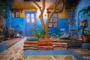 a blue room with a tree and a blue door at Mayelia Ηouse in the old town in Rhodes Town +61 photos