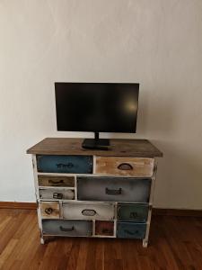 a tv sitting on top of a wooden dresser at La sosta 2-Casa accanto alla stazione dei treni in Modena