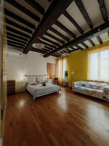 a large bedroom with two beds and a wooden floor at La sosta 2-Casa accanto alla stazione dei treni in Modena