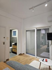 a living room with a couch and a large window at Elegant City Retreat Walk to Landmarks & Metro in Athens +12 photos