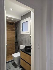 a bathroom with a toilet and a sink at Elegant City Retreat Walk to Landmarks & Metro in Athens
