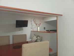 a dining room with a table and a tv at Casa amoblada eventual in Villa Mercedes