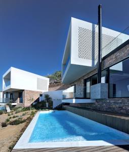 a house with a swimming pool in front of it at SEDUCTION Villa Thassos in Skala Kallirakhis