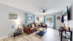 a living room with a couch and a ceiling fan at Two bedroom family home near Anschutz Medical in Aurora