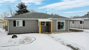 a house with a dog sitting in the snow at Two bedroom family home near Anschutz Medical in Aurora