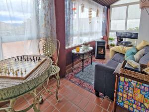 a living room with a chess board on a table at Piso vacacional en Casa Carroucha in Valga