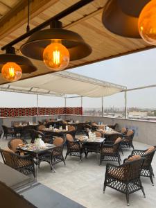 a dining room with tables and chairs and lights at IZUMRUD PALACE in Samarkand