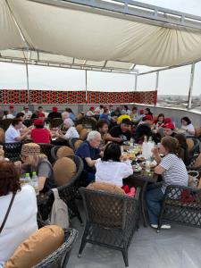 a group of people sitting at tables eating food at IZUMRUD PALACE in Samarkand