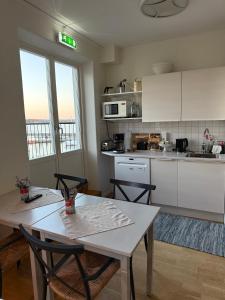 a kitchen with a table and two chairs in a room at Rindö Hamn Bed & Breakfast in Vaxholm
