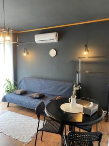 a living room with a blue couch and a table at INC apartment in villa in Bucharest