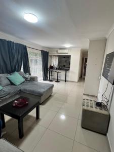 a living room with a couch and a table at 2 Bedroom Willow Park Apartment in Ballito