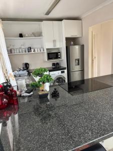 a kitchen with a stainless steel refrigerator and a stove at 2 Bedroom Willow Park Apartment in Ballito