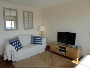 uma sala de estar com um sofá e uma televisão de ecrã plano em Apartamento Consolat de Mar Cambrils em Cambrils