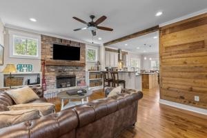 a living room with a couch and a fireplace at Hunter House Southern Pines in Southern Pines