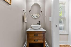 a bathroom with a sink and a mirror at Hunter House Southern Pines in Southern Pines +22 photos