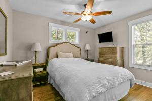 a bedroom with a bed and a ceiling fan at Hunter House Southern Pines in Southern Pines