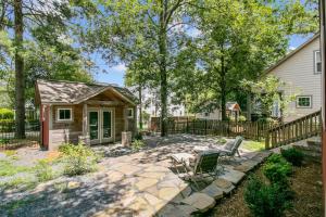 a backyard with a stone patio and a house at Hunter House Southern Pines in Southern Pines
