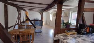 a living room with a table and a dining room at Ferienwohnung nähe Marburg und Gießen in Fronhausen