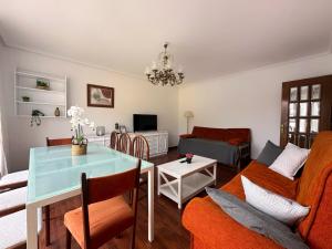 a living room with a table and a couch at Monuca - 3803 in Santoña