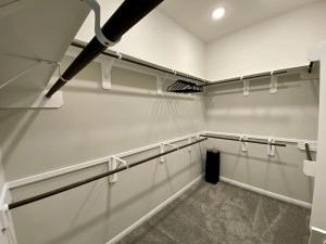a room with white walls and a row of racks at 4-BR Getaway Ideal for Families in Richmond