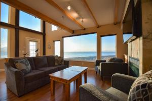 a living room with a couch and a table at Lakeshore Lodging Lodge 722 in Homer +21 photos