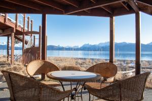 a table and chairs with a view of the water at Lakeshore Lodging Lodge 615 in Homer