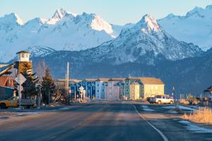 a street in a town with mountains in the background at Lakeshore Lodging Lodge 615 in Homer +7 photos
